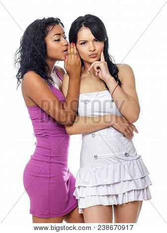 Two Best Friend Girls Wispering A Secret. Isolated On White Background.