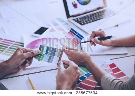 Cropped Image Of Beautiful Couple Of Designers Discussing Color Scale While Working In Office