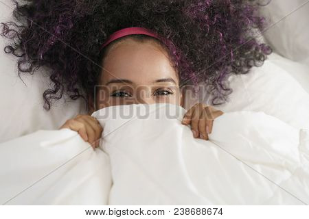 Portrait Of Happy Black Girl Looking At Camera Undercover. Young African American Woman Waking Up At