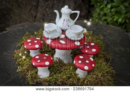 Tea Party With Fairies In Forest On Red Capped Mushrooms