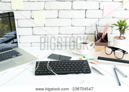 Close Up Gedgets On Workplace White Desk With Laptop And Smartphone