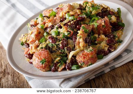 Brazilian Traditional Tropeiro Fried Beans With Greens, Sausages, Bacon And Eggs Close-up. Horizonta
