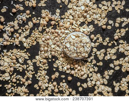 healthy diet raw cereals on the black table oatmeal