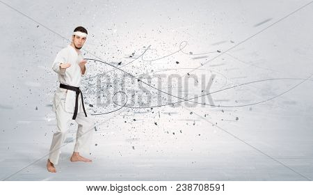 Young karate trainer doing karate tricks with chaotic concept