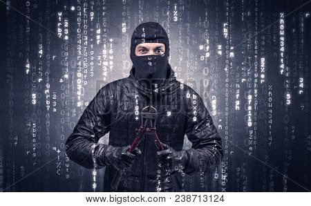 Burglar in action with encoded concept and his tools in his hand. 