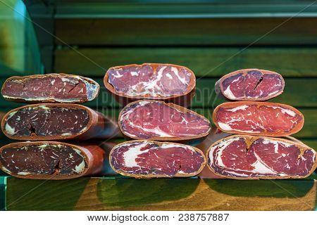 Dishes From Meat. Ham, Cold Boiled Pork, Salami, Basturma On The Counter In The Store