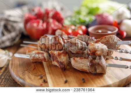 Shish Kebab From Pork. Appetizing Meat Cooked On An Open Fire And Fresh Vegetables. Rustic.