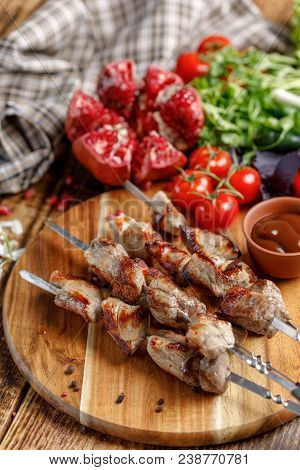 Shish Kebabs On Skewers Close-up. Juicy Appetizing Meat Cooked On An Open Fire. Rustic.