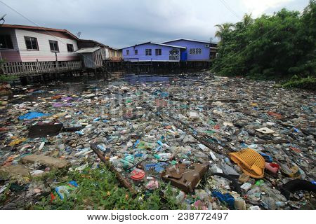 SEMPORNA, MALAYSIA - CIRCA MAY 2018: Plastic rubbish pollution in ocean. Plastic water bottles and bags thrown directly into the sea with no proper trash collection or recycling.