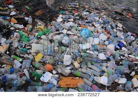 SEMPORNA, MALAYSIA - CIRCA MAY 2018: Plastic rubbish pollution in ocean. Plastic water bottles and bags thrown directly into the sea with no proper trash collection or recycling.