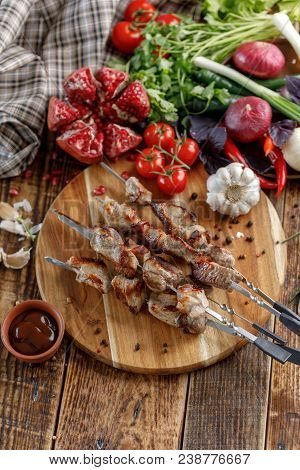 Shish Kebabs Cooked On An Open Fire. Still Life With Textiles On A Wooden Background.