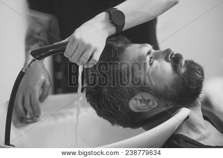 Man Wash Long Beard And Mustache. Hipster With Serious Face In Barbershop, New Technology. Haircut O