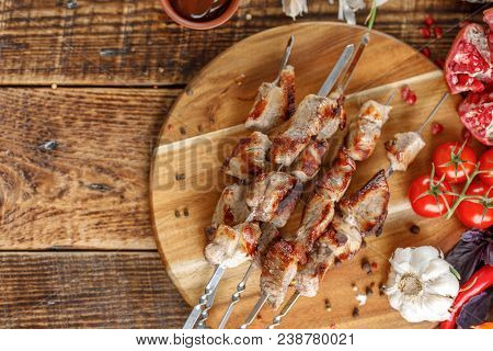 Delicious And Juicy Kebabs Of Pork On A Wooden Board. Still Life With Textiles On A Wooden Backgroun