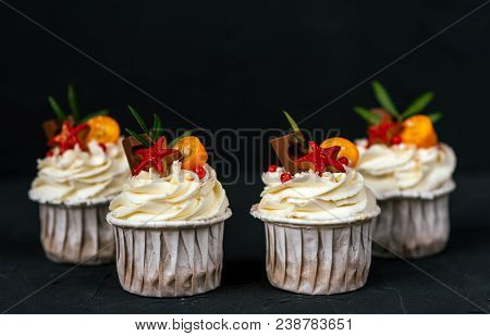 Four Puff Pastries With Cream, Chocolate Cakes With Biscuits. Close-up On A Black Background. In Whi