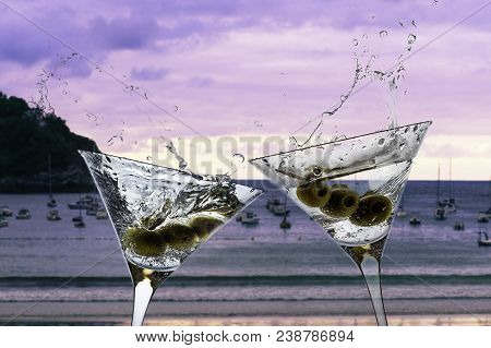 Cocktails With Splashining Martini On A Sunset Beach