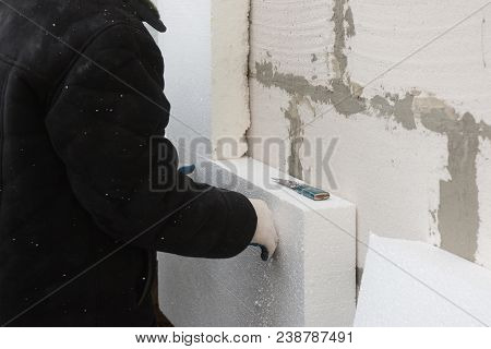 Builder Installing Rigid Styrofoam Insulation Board For Energy Saving. Rigid Extruded Polystyrene In