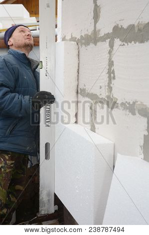Kyiv, Ukraine - May, 08, 2018: Building Contractor Insulating House Wall With Styrofoam Insulation S