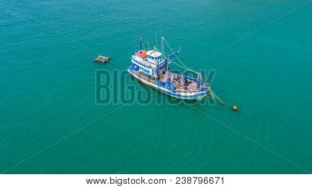 Fishing Boat Floating In The Sea. The Beautiful Bright Blue Water In A Clear Day.aerial View.top Vie