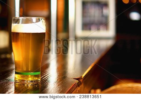 Pint Of Beer On A Bar In A Traditional Style Pub.