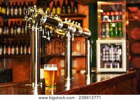 Pint Of Beer On A Bar In A Traditional Style Pub.