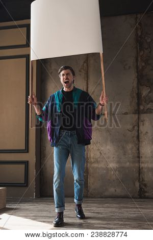 Angry Shouting Young Man In Vintage Windcheater With Blank Placard