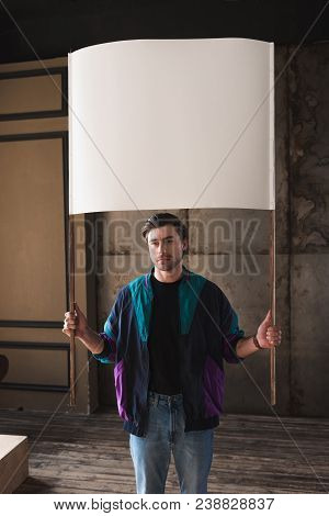 Serious Young Man In Vintage Windcheater With Blank Placard