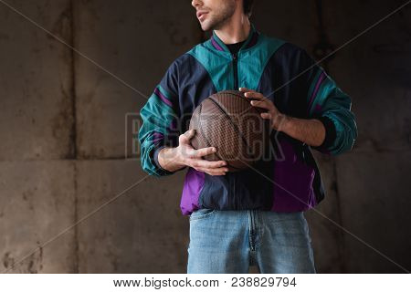 Cropped Shot Of Young Man In Vintage Windcheater With Basketball Ball