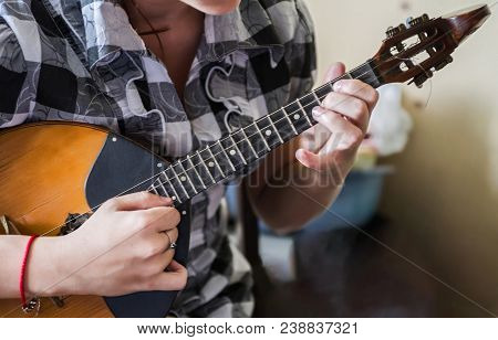 Hands Of A Musician Playing On Domra Tremolo. Hands Of The Musician On The Move. Selective Focus.