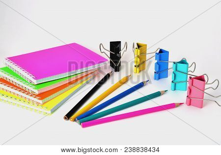 Colorful Notepads Clip For Paper And Pencils On A White Background In The Correct Geometry