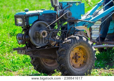 Motoblock Plows Soil In The Farm Summer.