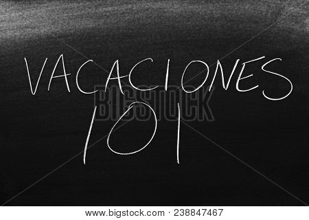 The Words Vacaciones 101 On A Blackboard In Chalk.  Translation: Vacation 101