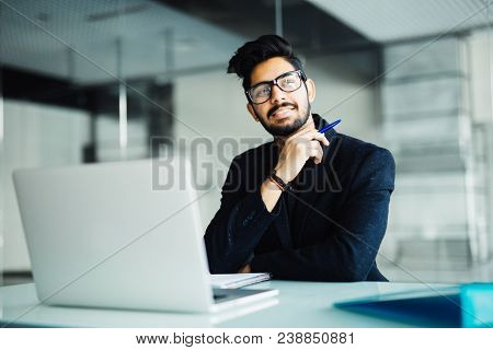 Business, People And Technology Concept - Businessman With Laptop Computer And Papers Working At Off