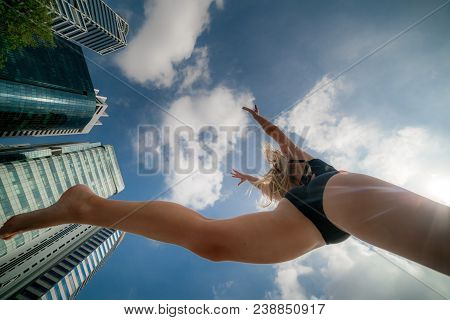 Low Angle Shot Of Passionate Beautiful Female Athlete Jumps High In The Ai
