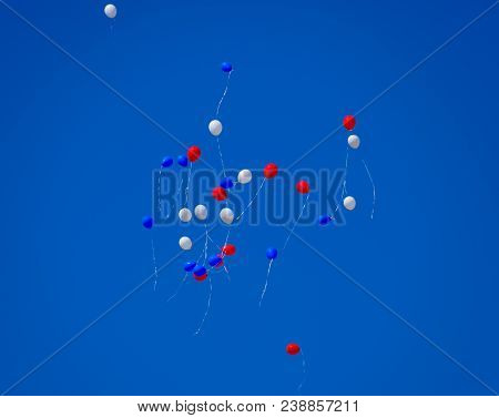 Multicolored Balls, Filled With Helium, Fly In The Blue Sky.