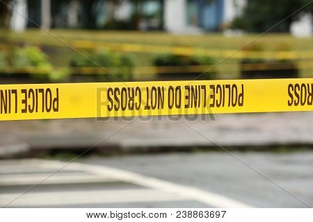 Yellow Police Line Tape Blocking The Road