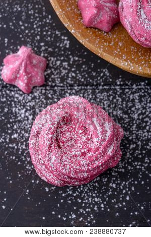 Close-up Meringues On Dark Wooden Background. Sweet Dessert