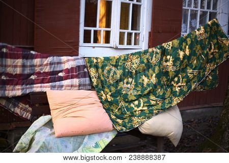 Wet Pillow Duvet Drying On The Sun On The Cottage House Background