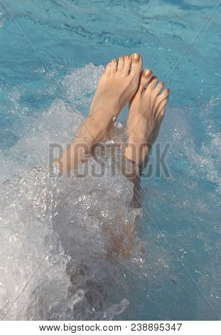 Feet Of Woman During The Whirlpool Therapy In The Spa Pool