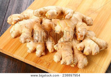 Spicy Root Of Ginger On A Wooden Table