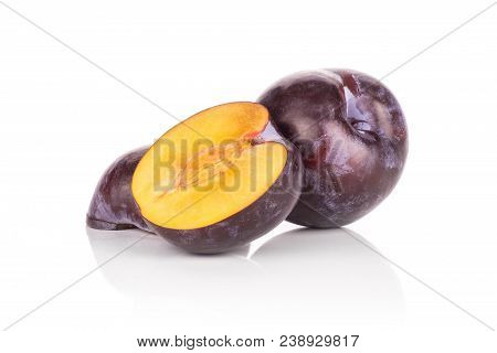 One Red Blue Plum And Two Halves Isolated On White Background