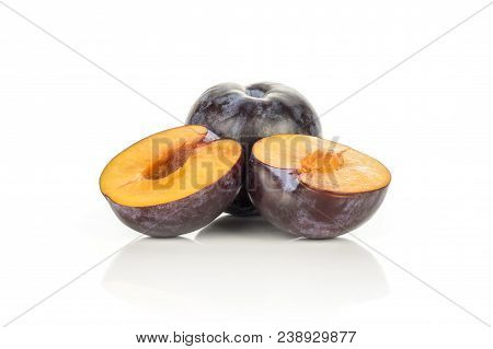 One Red Blue Plum With Two Sliced Halves Isolated On White Background