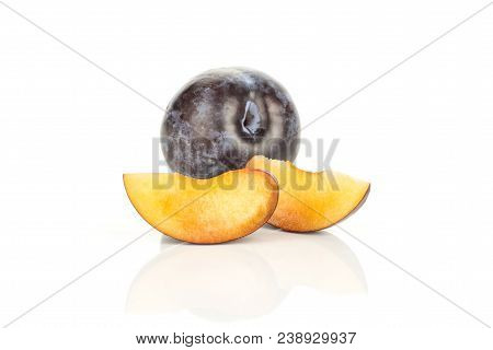 Two Red Blue Plum Slices And One Whole Isolated On White Background