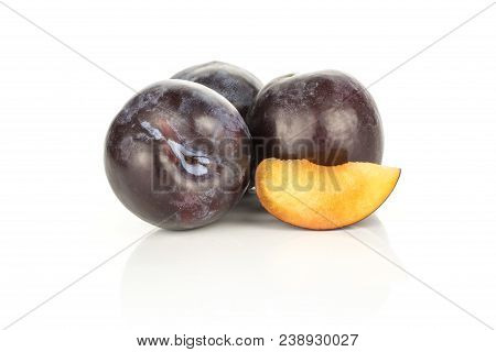 Three Red Blue Plums And One Slice Isolated On White Background