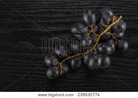 Black Grape Cluster (autumn Royal Variety) Table Top Isolated On Black Wood Background
