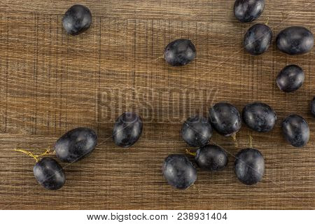 Black Grape Berries (autumn Royal Variety) Table Top Isolated On Brown Wood Background