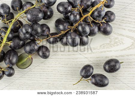 Black Grape Cluster (autumn Royal Variety) With Three Berries Table Top Isolated On Grey Wood Backgr
