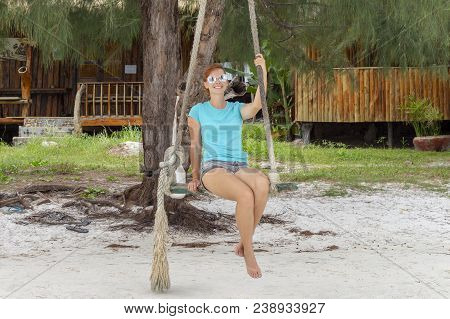 Smiling Woman In Sunglasses On Beach Swing. Tropical Island Vacation Relax By Sea. White Sand Beach 