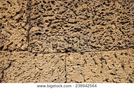 Rough Stone Ancient Wall Closeup Photo. Stone Wall Texture. Rustic Stone Wall Of Ancient Building. G