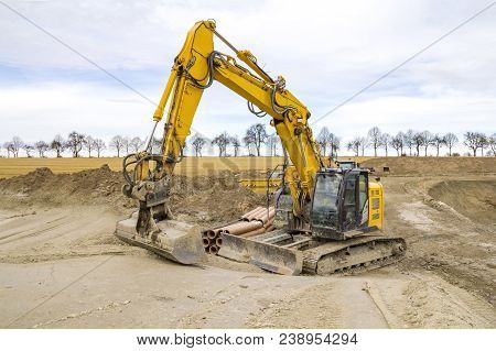 Yellow Excavator At A Loamy Construction Site