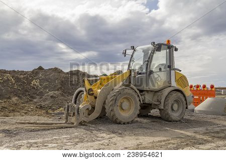 Yellow Loader At A Loamy Construction Site